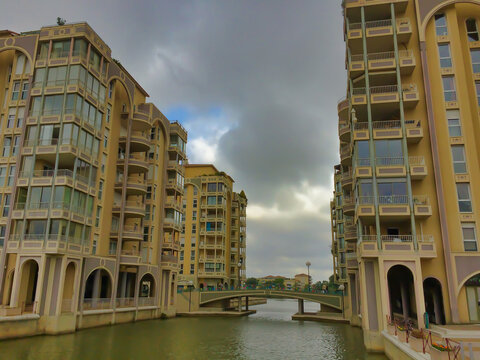 modern residential and commercial complex mediterranean style with canal and bridge, France, Lattes, Port-Ariane