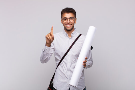 Young Architect Man Smiling And Looking Friendly, Showing Number One Or First With Hand Forward, Counting Down