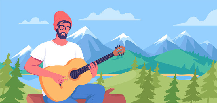 Young man playing guitar on the colorful mountains landscape 