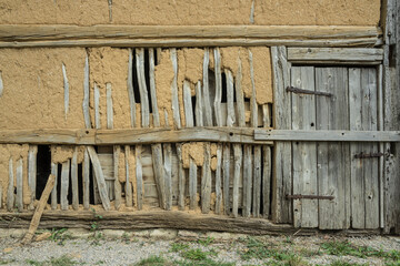 barn wall with wooden framework and clay