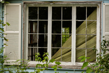 Weatherd window on an abandoned house
