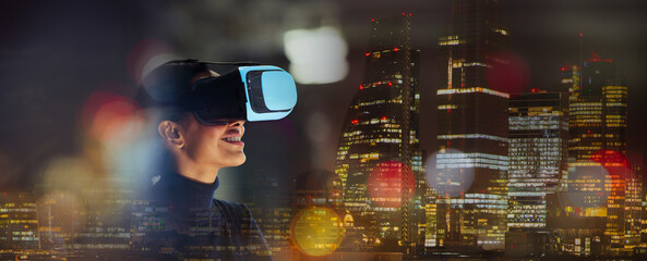 Smiling businesswoman using virtual reality glasses in city at night