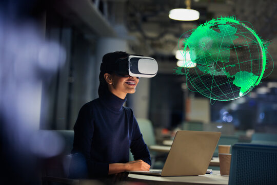 Businesswoman with virtual reality glasses looking at globe