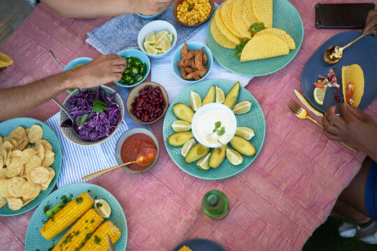 Taco shells and ingredients on patio table