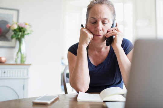 Woman working from home talking on telephone