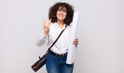 young architect woman smiling and looking friendly, showing number three or third with hand...