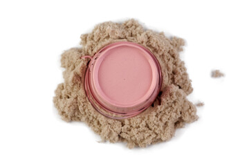 Bucket and sand isolated on white background. Decorative small pink bucket and kinetic sand, with...
