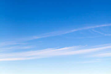 Blue sky with stripes of cirrus clouds at daytime