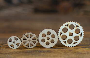 wooden gears on a wooden background
