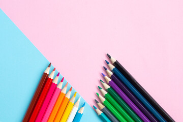 Color pencils on blue and pink background.