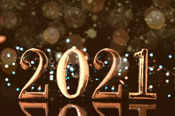 Christmas year from golden numbers with gold sparkle bokeh abstract background 