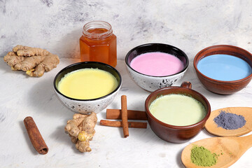 Assortment of colorful Japanese tea latte, golden turmeric, matcha, blue, pink moon milk. Anti-inflammatory, immunity-boosting, alternative medicine, selective focus