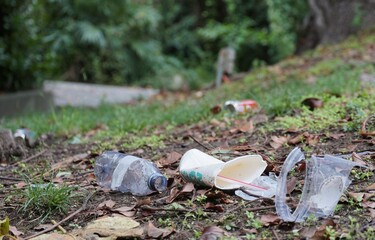 Garbage or litter food containers spread in the park polluting the environment and deteriorating...