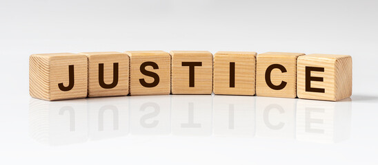 Justice word on cube blocks on white glossy background with reflection, banner