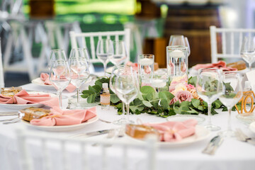 Luxury wedding table decoration in pink and white. Special event table set up. Fresh flower decoration.