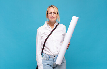 young architect woman feeling sad and whiney with an unhappy look, crying with a negative and...