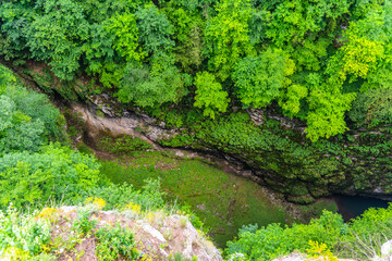 Macocha Abyss - large limestone gorge in Moravian Karst, Czech: Moravsky Kras, Czech Republic. View from the top - upper lookput platform