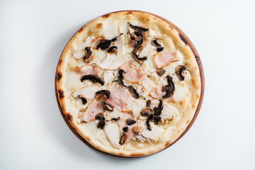 Italian pizza with ham, chicken and mushrooms.