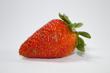 Strawberry with green leaves and white background