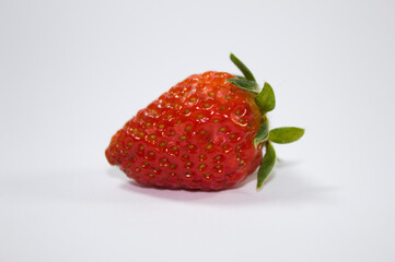Strawberry with green leaves and white background