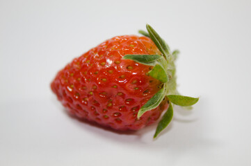 Strawberry with green leaves and white background