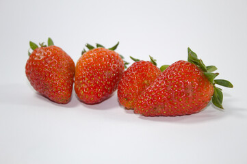 Strawberry with green leaves and white background