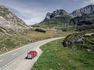 Vanlife in an old red firetruck on Julierpass, Switzerland