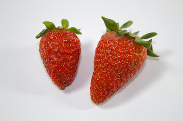 Strawberry with green leaves and white background