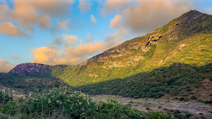 green mountains in salalah with cloudy sky