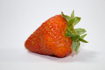 Strawberry with green leaves and white background