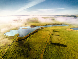 aerial photo of morning fog on small lakes
