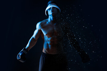 Muscular model sports young man in glasses of virtual reality and boxing gloves on dark background....