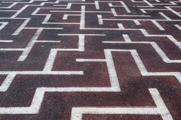 Background as a labyrinth painted with white paint on the asphalt, horizontal orientation