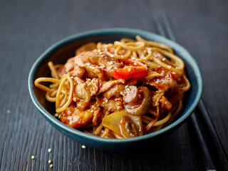 fried noodles and vegetables with hot chicken sauce