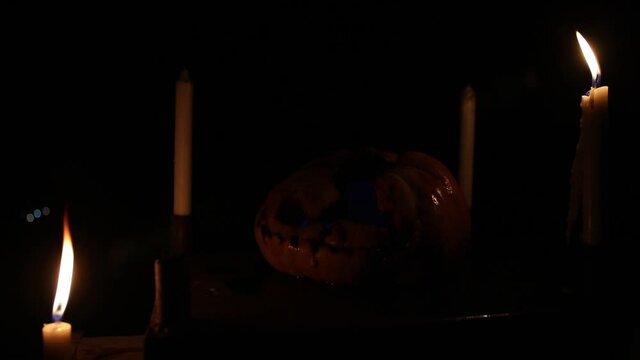 Horror Halloween concept. Close up view of scary dead Halloween pumpkin. Rotten pumpkin head. Selective focus