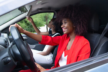 two African American women having fun in the car