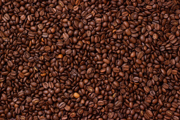 Grains coffee. Background from coffee beans. Roasted coffee beans. Brown coffee beans in whole background.