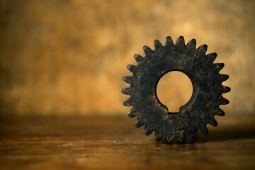 Old wooden gear on a retro background