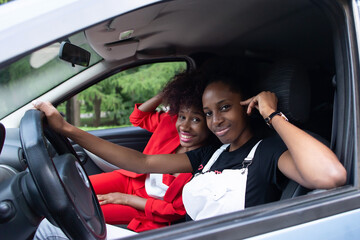 two African American women having fun in the car