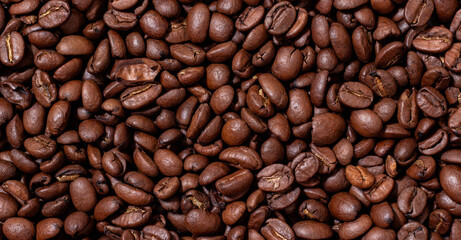 Background from coffee beans. Roasted coffee beans. Brown coffee beans in whole background.