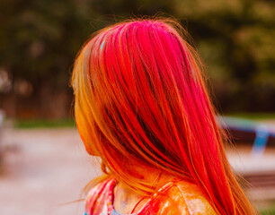 Naklejka premium girl's hair painted with Holi festival colours