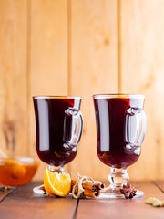 Mulled wine on a wooden boards. Autumn mulled wine, spices and honey. Christmas hot drink in rustic style