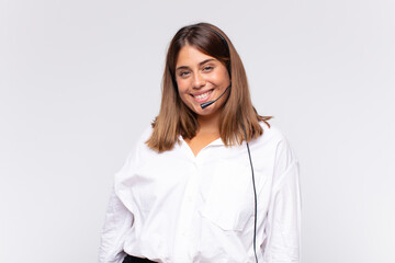 young woman telemarketer looking happy and pleasantly surprised, excited with a fascinated and...
