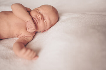 Cute emotional newborn funny little baby boy sleeping in crib. Baby goods packaging template. Healthy child, concept of hospital and happy motherhood. Infant baby. Nursery