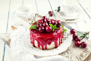 Traditional cherry cheesecake with fruits offered as close-up on design plate