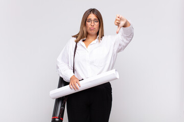 young architect woman feeling cross, angry, annoyed, disappointed or displeased, showing thumbs down with a serious look © kues1
