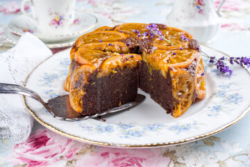 Traditional orange chocolate cake offered as close-up on on a design plate