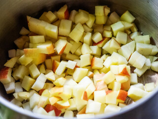 Closeup photo small pieces of apple lie at the bottom of the pan