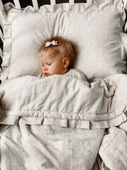 child sleeping on bed