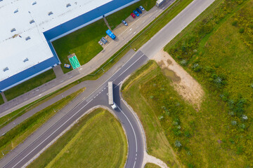 Aerial view of goods warehouse. Logistics center in industrial city zone from drone view. Background texture concept.